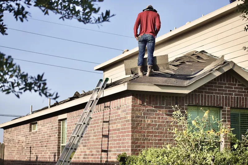Professional roofer working on a residential roof in Virginia City